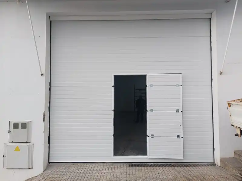 Puerta seccional industrial de gran formato con motor lateral instalada en nave de Tenerife